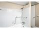 Bathroom featuring a tiled shower and bathtub combination with safety bars and a shower head at 3736 Sail Dr, New Port Richey, FL 34652