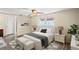 Cozy bedroom featuring neutral tones, wood-look floors, ceiling fan, and a comfortable bed setup at 3736 Sail Dr, New Port Richey, FL 34652