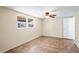 Simple bedroom with wood-look flooring, a ceiling fan, and a window overlooking the exterior at 3736 Sail Dr, New Port Richey, FL 34652