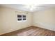 Bedroom with wood-look flooring, a ceiling fan with lighting, and a double window with blinds at 3736 Sail Dr, New Port Richey, FL 34652