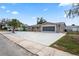 Attractive home features a wide driveway, mature palm trees and a secure garage at 3736 Sail Dr, New Port Richey, FL 34652
