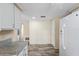 Kitchen featuring granite countertops, white cabinets, stainless appliances, and hardwood-style floors at 3736 Sail Dr, New Port Richey, FL 34652