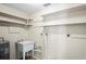 Functional laundry room boasts utility sink, ample shelving and efficient water heater at 3736 Sail Dr, New Port Richey, FL 34652