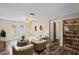 Bright living room with hardwood floors and a view to the backyard, filled with natural light at 3736 Sail Dr, New Port Richey, FL 34652