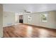 Open living room showcases hardwood floors, a ceiling fan, bright windows and a front door, offering an inviting space at 3736 Sail Dr, New Port Richey, FL 34652