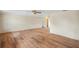 Empty living room featuring hardwood floors, neutral wall paint, white trim, and a ceiling fan, providing a blank canvas at 3736 Sail Dr, New Port Richey, FL 34652