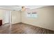 Empty main bedroom featuring neutral decor, hardwood floors, and ample natural light at 3736 Sail Dr, New Port Richey, FL 34652