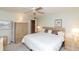 A bright bedroom shows a large bed, ceiling fan, and decorative headboard and dresser at 4533 Marine Pkwy # 206, New Port Richey, FL 34652