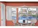 A dining area with a view of the water and neighboring properties through large windows at 4533 Marine Pkwy # 206, New Port Richey, FL 34652