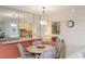 Dining room with a mirrored wall that reflects the kitchen and stylish light fixture above at 4533 Marine Pkwy # 206, New Port Richey, FL 34652