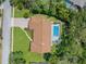 Aerial view of the home showcasing the backyard pool and lush surroundings at 4603 Lake In The Woods Dr, Spring Hill, FL 34607