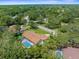 Sprawling home boasts a screened-in pool area, lush landscaping, and mature trees, offering a private oasis at 4603 Lake In The Woods Dr, Spring Hill, FL 34607