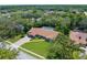A charming home with lush green lawn and mature trees, offering a serene and private outdoor experience at 4603 Lake In The Woods Dr, Spring Hill, FL 34607