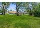 Spacious backyard featuring a well-maintained lawn and screened-in lanai, perfect for relaxing or entertaining outdoors at 4603 Lake In The Woods Dr, Spring Hill, FL 34607