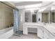 Bright bathroom with a bathtub, integrated vanity and countertop, and an oversized mirror at 4603 Lake In The Woods Dr, Spring Hill, FL 34607