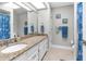 Bright bathroom featuring granite countertops, a sink with fixtures, and tile floors at 4603 Lake In The Woods Dr, Spring Hill, FL 34607