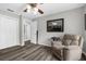 Bedroom featuring luxury vinyl flooring, a ceiling fan, closet, and an comfortable chair at 4603 Lake In The Woods Dr, Spring Hill, FL 34607