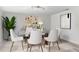 Bright dining room featuring a glass table, neutral chairs, and elegant decor at 4603 Lake In The Woods Dr, Spring Hill, FL 34607