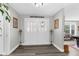 Welcoming foyer with double doors, wood-look floors, and decorative accents at 4603 Lake In The Woods Dr, Spring Hill, FL 34607