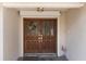 Front door with glass panes and a decorative wreath with flamingo decoration at 4603 Lake In The Woods Dr, Spring Hill, FL 34607