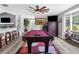 Entertaining game room with pool table, wet bar and adjacent seating area at 4603 Lake In The Woods Dr, Spring Hill, FL 34607