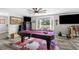 Cozy game room featuring a pool table, mounted TVs, and a bay window with seating at 4603 Lake In The Woods Dr, Spring Hill, FL 34607