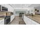 Well-lit kitchen with granite countertops and stainless steel appliances overlooking the pool at 4603 Lake In The Woods Dr, Spring Hill, FL 34607