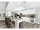 Spacious kitchen featuring white cabinets, a breakfast bar, and modern appliances at 4603 Lake In The Woods Dr, Spring Hill, FL 34607