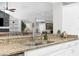 Kitchen area with granite countertops and an undermount sink with views to the living room at 4603 Lake In The Woods Dr, Spring Hill, FL 34607