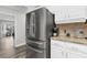 Stainless steel refrigerator and granite countertop with modern amenities creating an efficient cooking space at 4603 Lake In The Woods Dr, Spring Hill, FL 34607