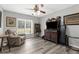 Living room featuring luxury vinyl flooring, a ceiling fan, and a window with natural light at 4603 Lake In The Woods Dr, Spring Hill, FL 34607