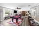 An expansive living room features a wet bar, pool table, bench seating, and lots of seating at 4603 Lake In The Woods Dr, Spring Hill, FL 34607