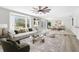 Open-concept living room and dining area with large windows and stylish furnishings at 4603 Lake In The Woods Dr, Spring Hill, FL 34607