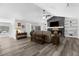 Comfortable living room with vaulted ceiling, stone fireplace, and stylish decor at 4603 Lake In The Woods Dr, Spring Hill, FL 34607