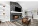Stone fireplace with a flat screen TV above the mantle and built-in shelves add warmth and charm to the space at 4603 Lake In The Woods Dr, Spring Hill, FL 34607