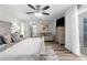 The main bedroom is spacious and bright, with a ceiling fan, hardwood floors, and ensuite bath at 4603 Lake In The Woods Dr, Spring Hill, FL 34607