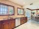 An eat-in kitchen with custom wood cabinets, granite counters, stainless steel appliances, and a view to the dining area at 4929 N River Shore Dr # A, Tampa, FL 33603