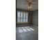 Sunlit bedroom featuring large windows with shutters, neutral paint, and tile flooring at 5000 Culbreath Key Way # 9-221, Tampa, FL 33611