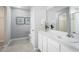 Bright bathroom boasts a large mirror, white cabinets, and elegant tile flooring at 625 171St E St, Bradenton, FL 34212