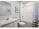 Well-lit bathroom with white fixtures, a tub/shower combo, and blue accents at 625 171St E St, Bradenton, FL 34212