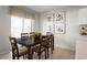 Bright dining area with a large window, a table for six, and decor art on the wall at 625 171St E St, Bradenton, FL 34212