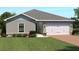 Charming single-story home featuring a two-car garage, neutral paint, and well-manicured landscaping at 625 171St E St, Bradenton, FL 34212