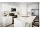 Kitchen featuring stainless steel appliances, white cabinets and an island with sink and seating at 625 171St E St, Bradenton, FL 34212