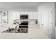 Kitchen with stainless steel appliances, white cabinets and an island with a stainless steel sink at 625 171St E St, Bradenton, FL 34212