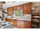 Charming kitchen with vintage wood cabinetry and a view of the backyard from above the sink at 705 Riverside Dr, Tarpon Springs, FL 34689