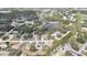 Wide aerial view of neighborhood showcasing ponds, mature trees, and community features at 7399 Skylark Dr, Spring Hill, FL 34606