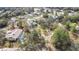 An aerial view of the property showcasing the pool and surrounded by mature trees at 7399 Skylark Dr, Spring Hill, FL 34606