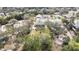 Aerial view of the neighborhood showcasing mature trees and residential properties at 7399 Skylark Dr, Spring Hill, FL 34606