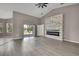 Open living room featuring hardwood floors, a modern fireplace, and sliding glass doors at 7399 Skylark Dr, Spring Hill, FL 34606