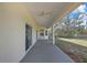 Covered patio with ceiling fans and a view of the spacious backyard and mature trees at 7399 Skylark Dr, Spring Hill, FL 34606